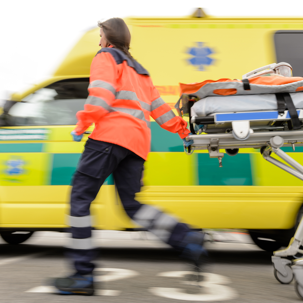 Paramedic pulling a stretcher in an emergency situation